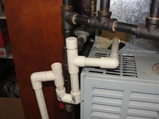 Condensate drain trap beneath an air handler